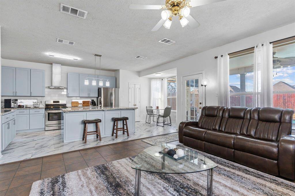 The family area seamlessly flows into the casual dining and gourmet kitchen. French doors open to a spacious pantry, while offering an outstanding view of the pool and your private lot!