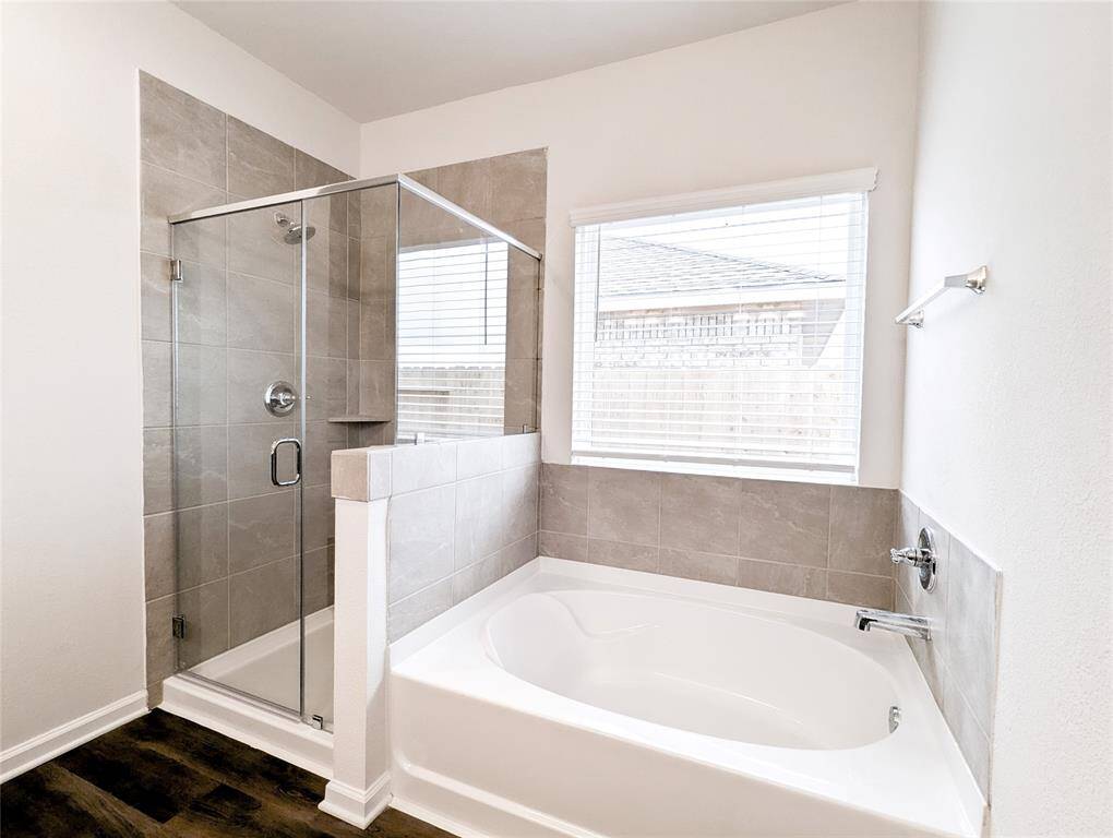 Master bath has separate shower and soaking tub
