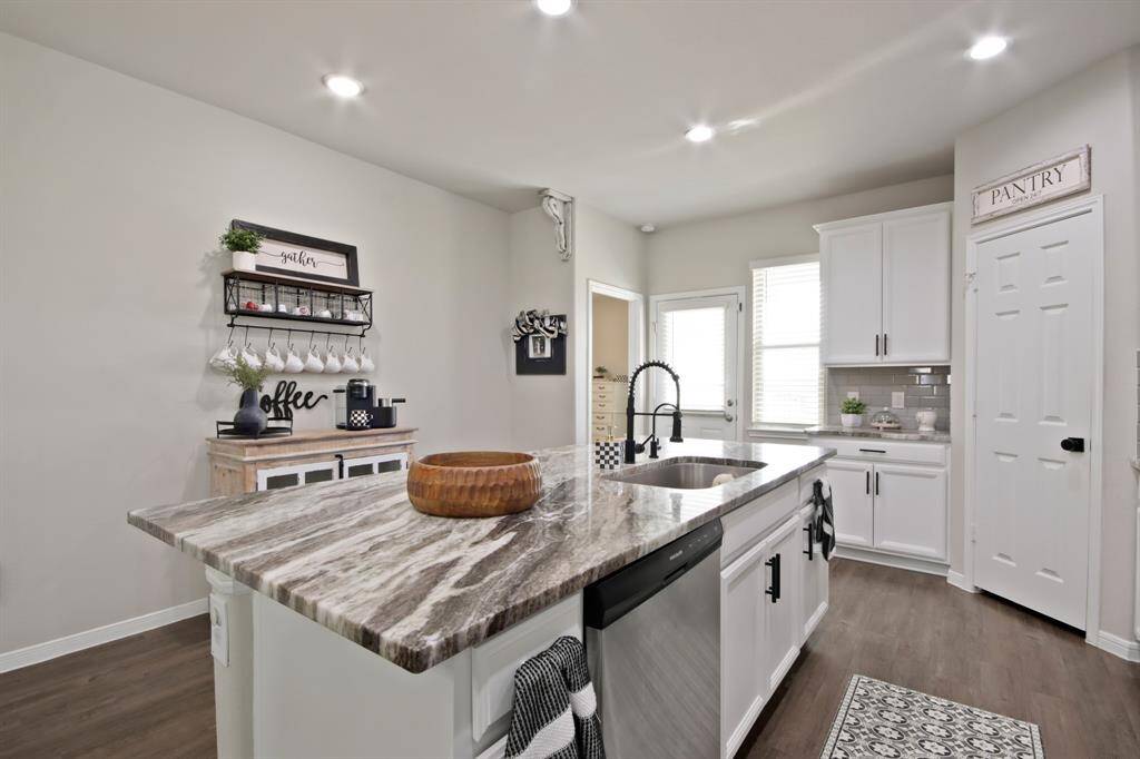 This kitchen area is spacious enough for a cozy coffee nook and a walk-in pantry, offering ample storage and a welcoming atmosphere.