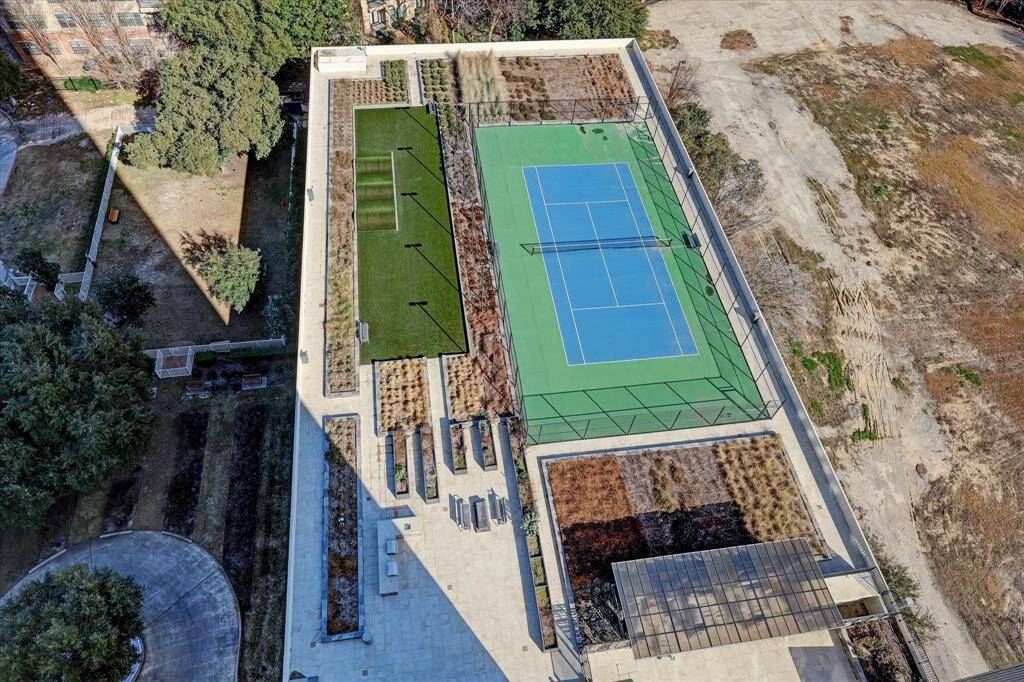 A tennis court! With dog walking area adjacent, as well as two grills.