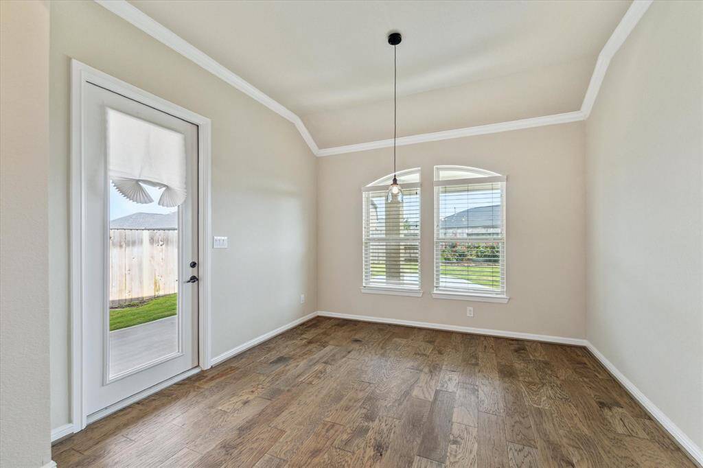 Plenty of space to dine in the Dining Room that is open to the kitchen and family room.  Door leads to the extended back patio.