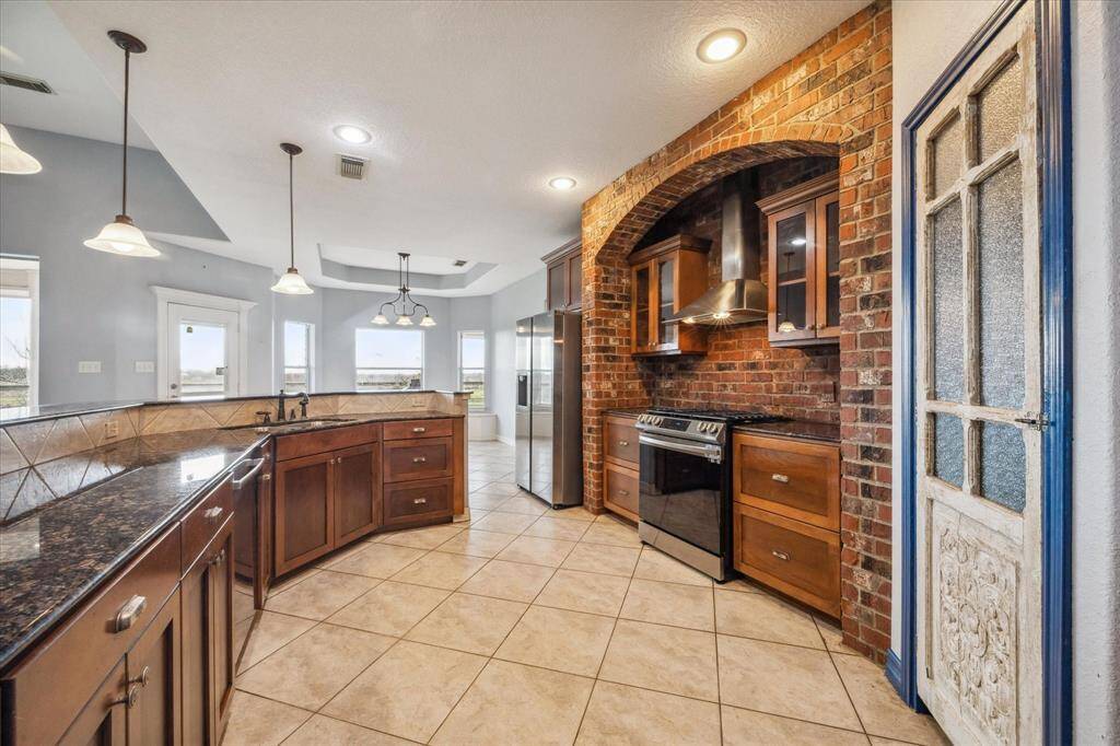 Spacious kitchen with stunning full brick design wall with arch