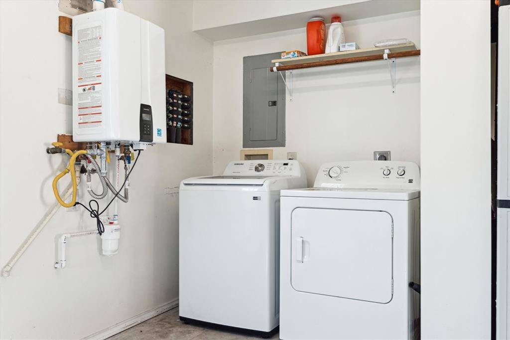 The utility/laundry area is finished with a side-by-side washer-dryer and storage.