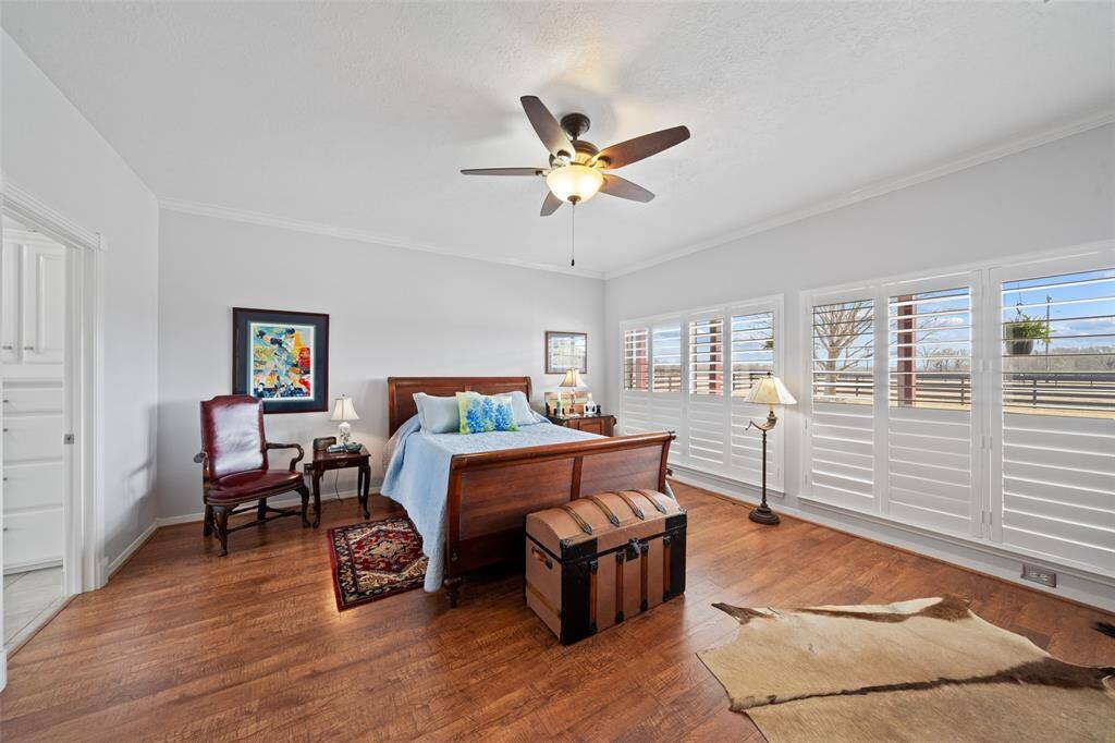 The primary suite features amazing wood floors and all the windows you could need, while allowing for privacy with the black out shutters that are so easy to use!