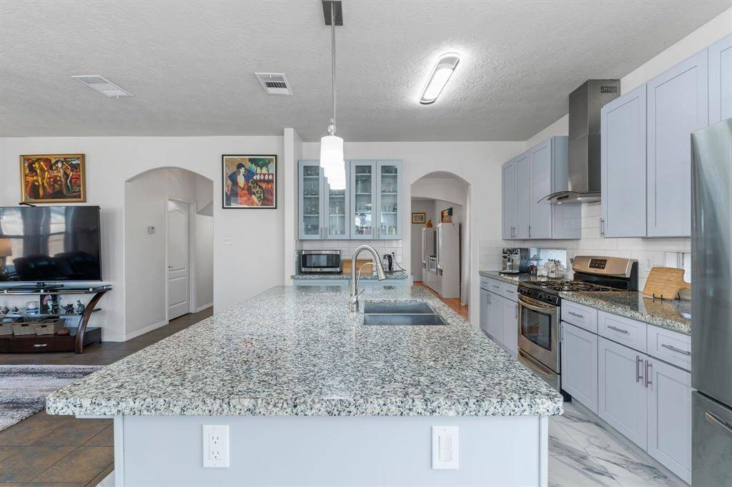 Admire the stunning pendant lighting above the gorgeous granite eat-in island!