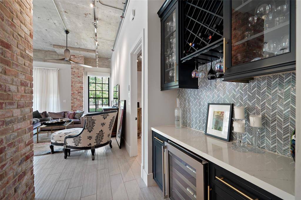 Featuring stunning brick-covered columns and exposed concrete, this home also includes a beverage pantry with a wine unit for your enjoyment.Featuring stunning brick-covered columns and exposed concrete, this home also includes a beverage pantry with a wine unit for your enjoyment.