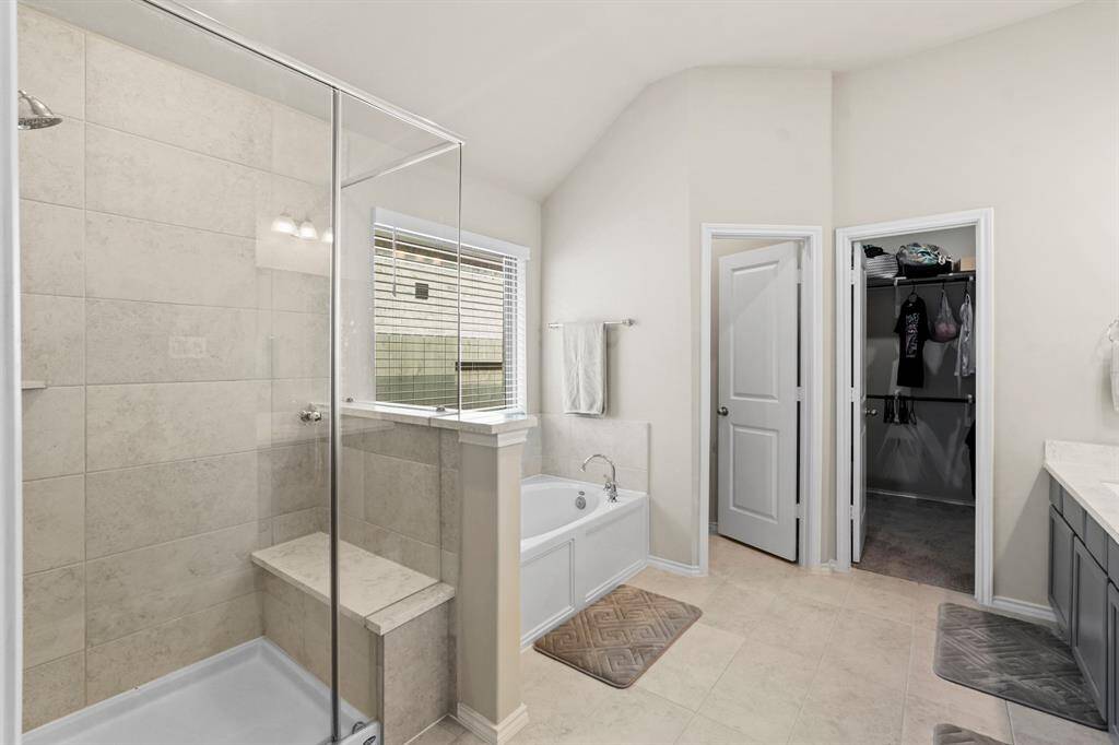 Spacious walk-in shower with seating bench