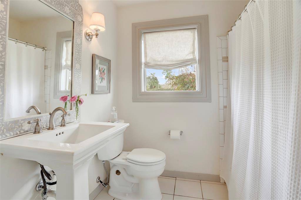 The shared bathroom sits between the two secondary bedrooms and accessible from the living room for guests.