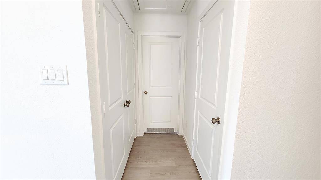 Hallway to in-house laundry room and bedroom 2