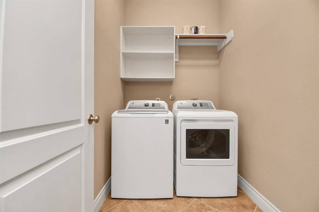 Utility area with hanging and storage shelf