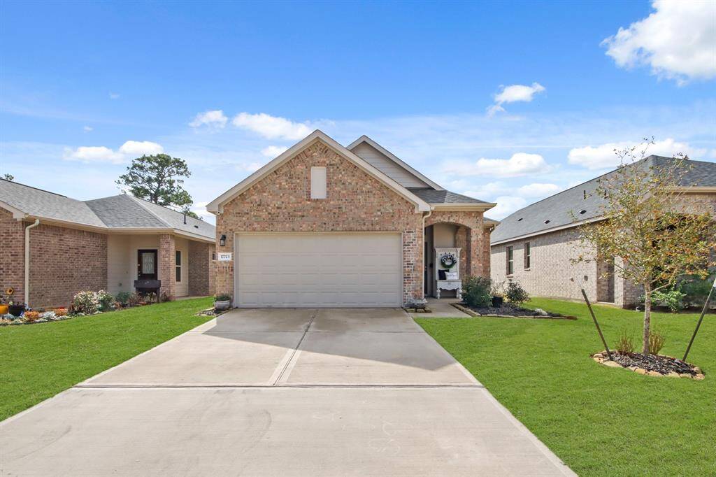 Charming brick home with a modern design, featuring a two-car garage and a well-maintained front lawn. The exterior has a welcoming entrance with a small porch and tasteful landscaping. Ideal for comfortable living in a friendly neighborhood.
