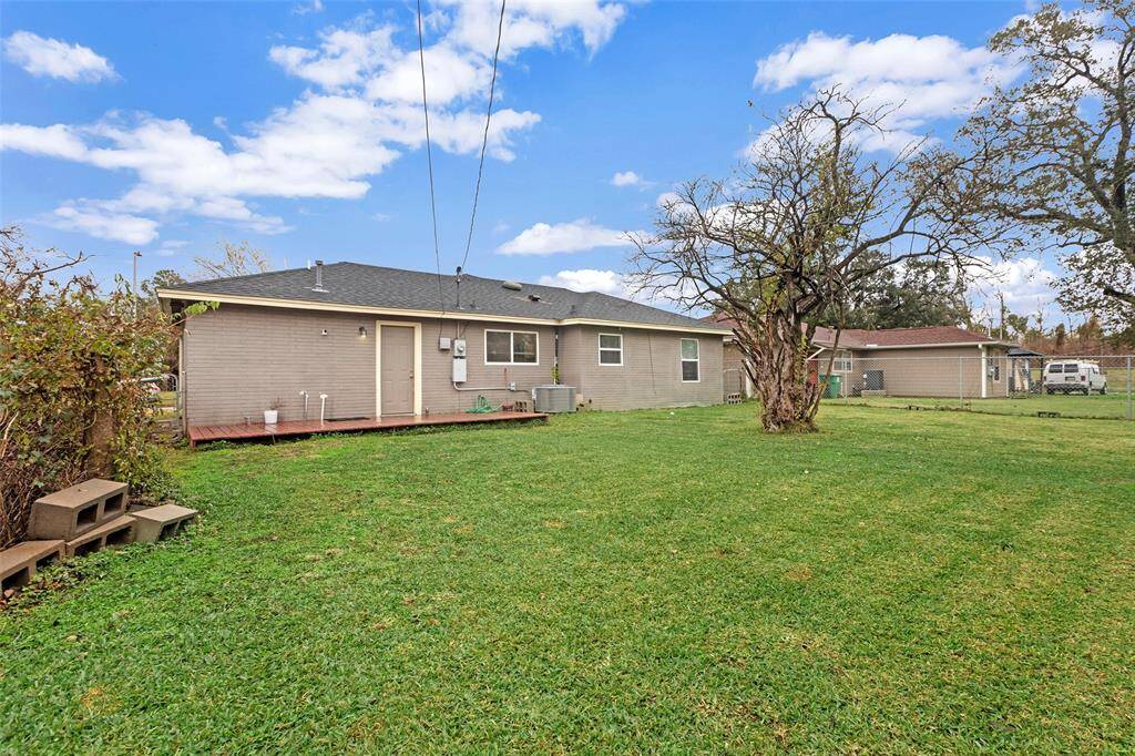 Surrounded by mature trees and a lush, green lawn, this backyard offers a serene and peaceful setting for outdoor enjoyment.