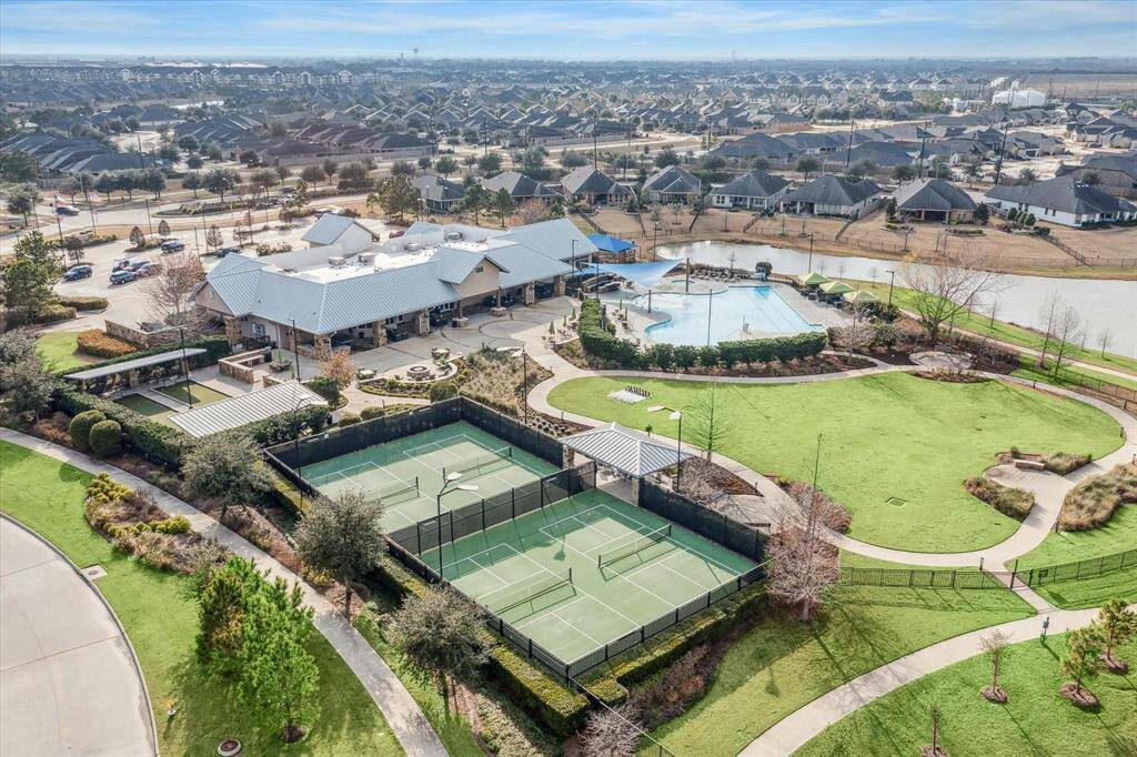 View of the clubhouse complex which is exclusive to Bonterra residents.  It features resort style pool, pickle ball courts, outdoor chess set, firepits, ping pong tables, walking trails and over 10,000 sq ft clubhouse with updated work out area, exercise room, pool tables, game room and where many community events are held.