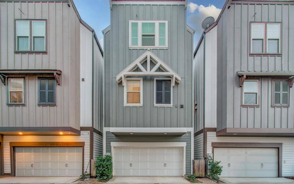 Back of home with garage access