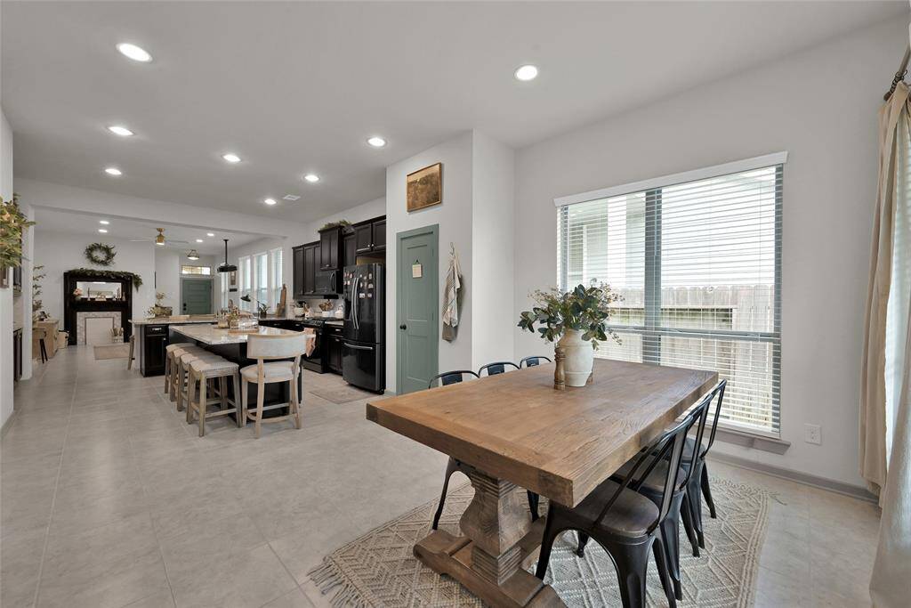 Island with bar seating, open to thedining area with amplenatural light.