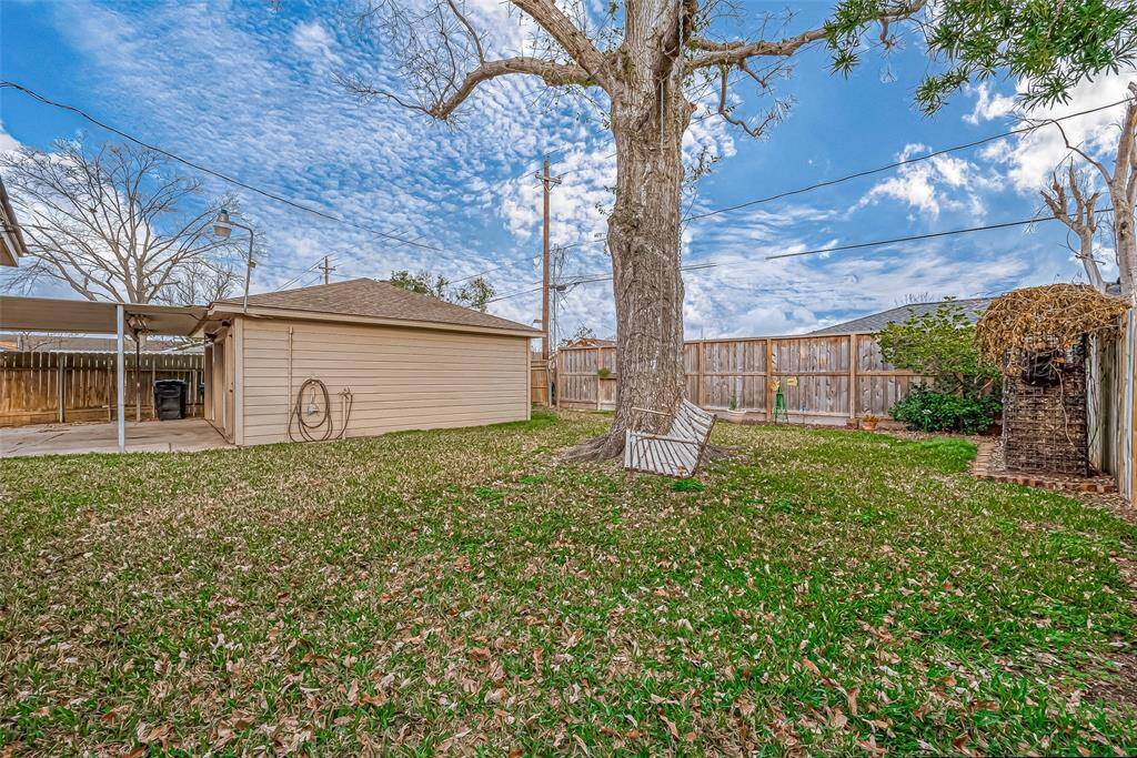 This spacious backyard offers endless possibilities for outdoor enjoyment, relaxation, and entertainment. The large, mature tree serves as a beautiful focal point, providing shade and the perfect spot to hang a hammock or swing, creating a peaceful retreat for unwinding with a book or enjoying the breeze.