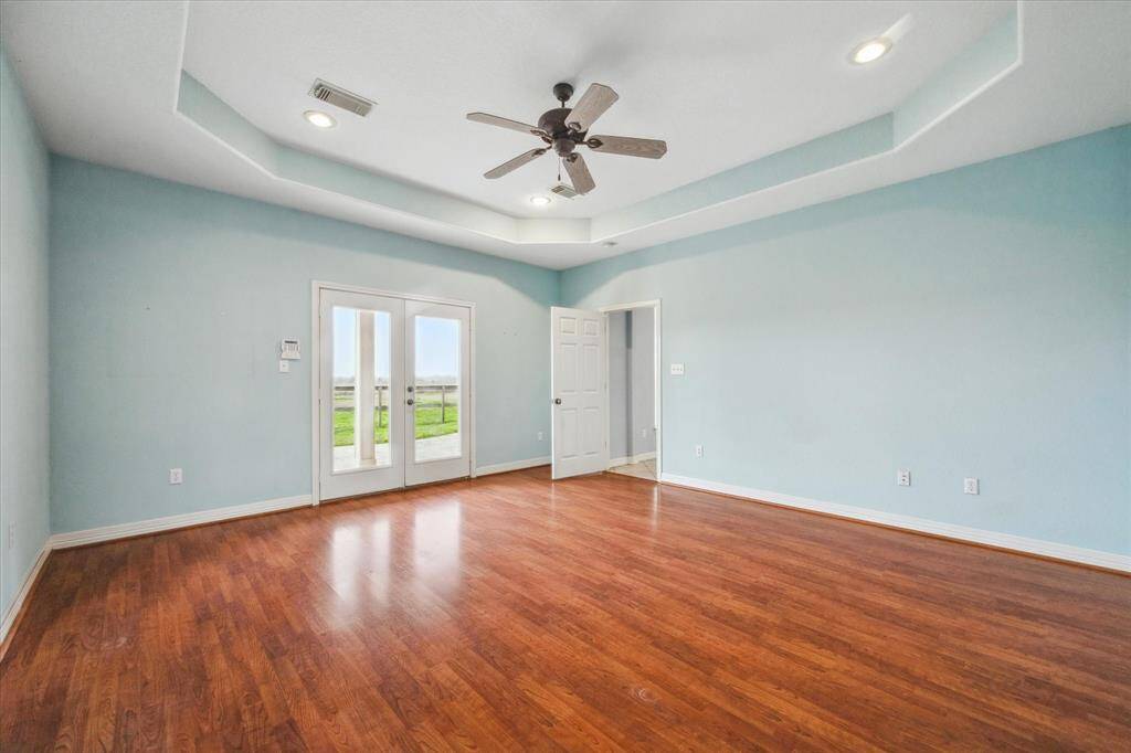 Primary suite with double doors leading to the back patio