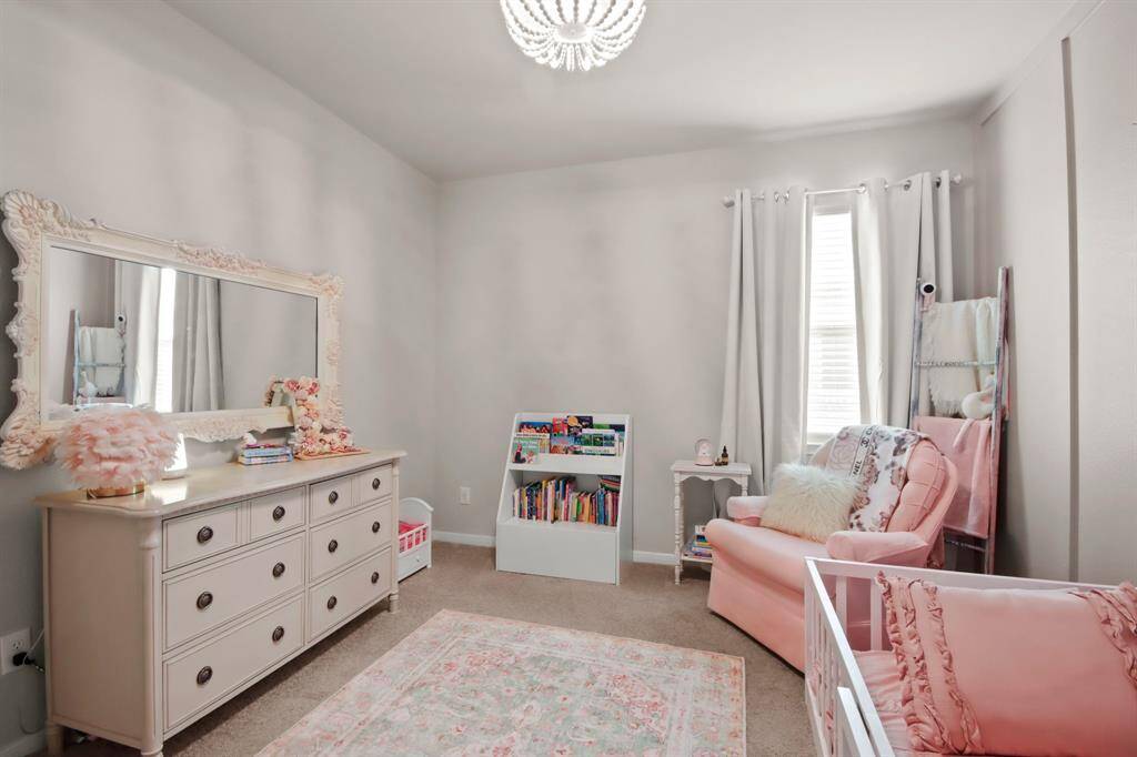 Another view of the spacious bedroom with a large window exuding natural light. Such a sweet, cozy space.