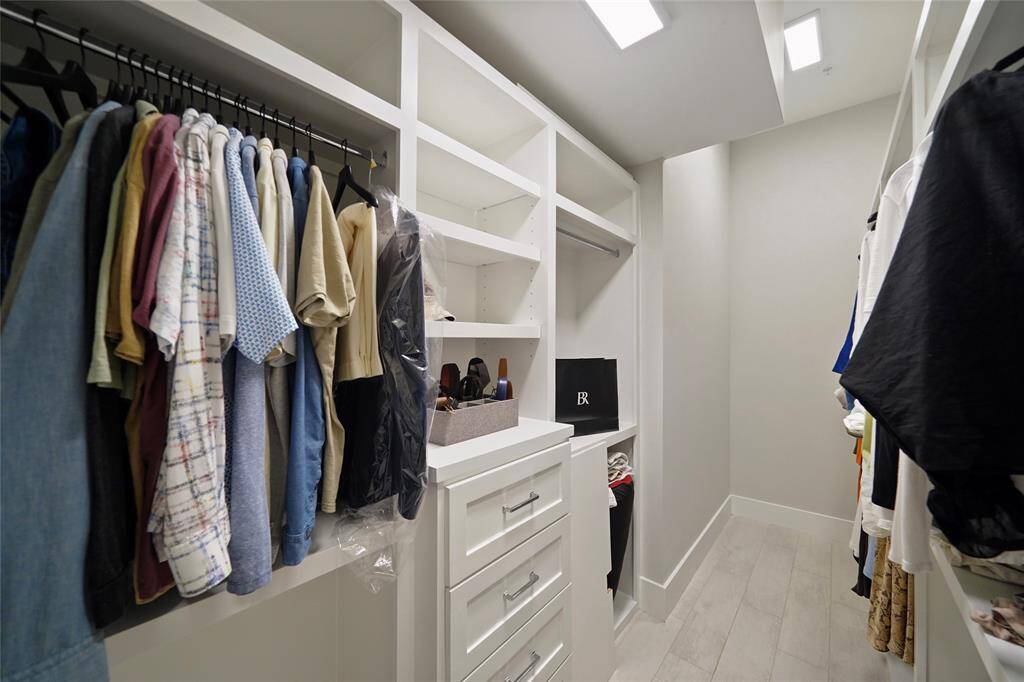 The spacious walk-in closet, with additional built-ins, offers ample storage for all your wardrobe essentials.