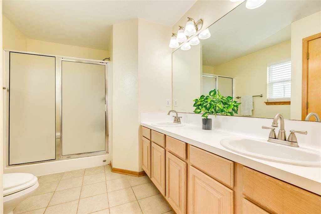 Primary Bathroom features a new counter top, double sinks and a walk-in shower