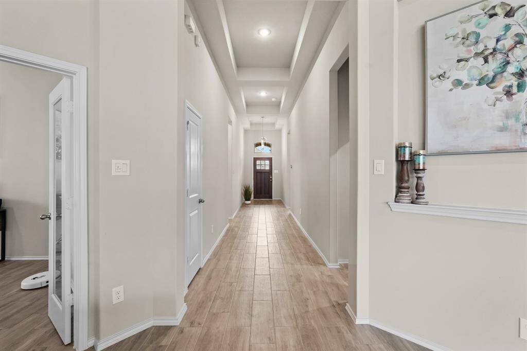Long, extended entry with custom coffered ceilings makes this home super inviting to walk into