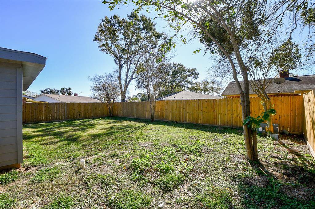 This backyard features new solid board fencing providing more privacy.