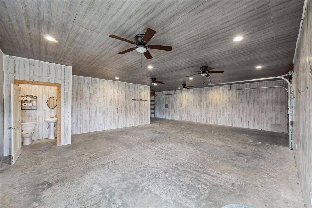 Finished out Shop space view from the door, 1/2 bath, shop sink, 2 garage doors
