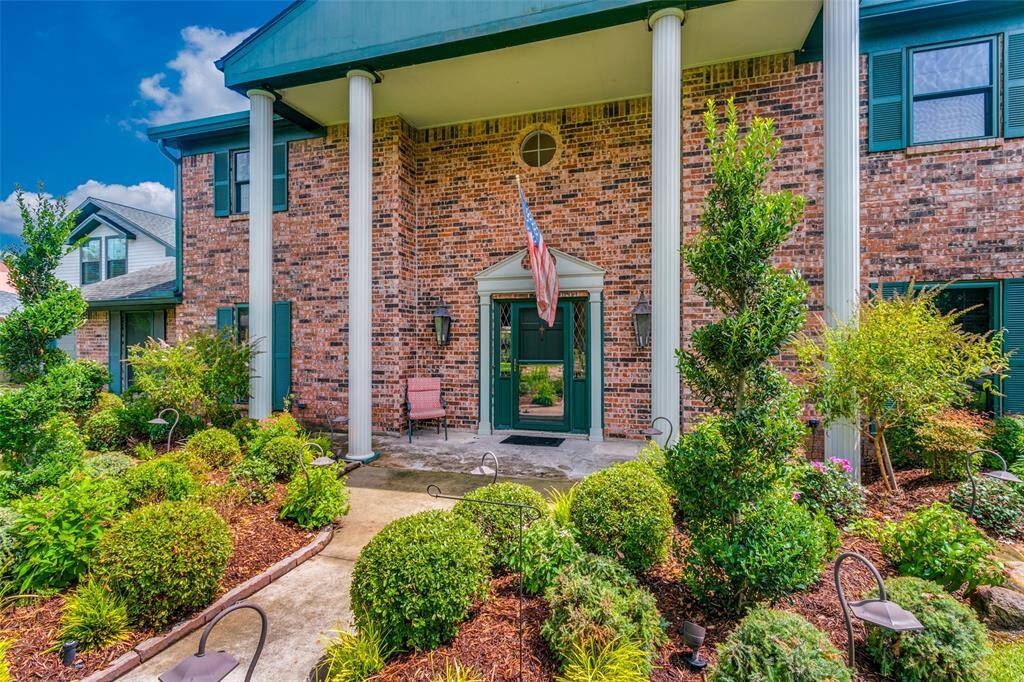 This two-story home with a welcoming entryway flanked by stately columns and a well-manicured yard, it gives it a charming and established look.
