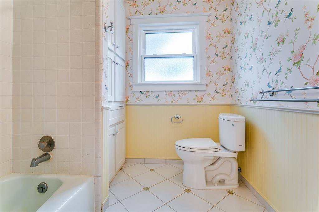 Another view which shows full bathtub with shower.