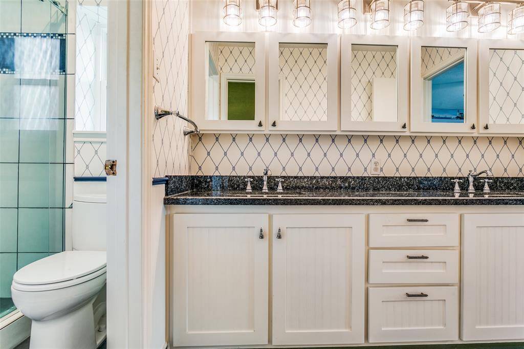 Another view of bathroom showing ample storage above and below vanity.