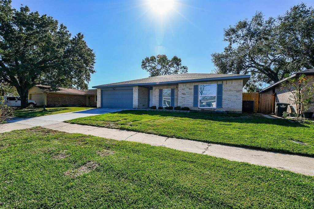 The home has a 2-car garage with a long driveway.