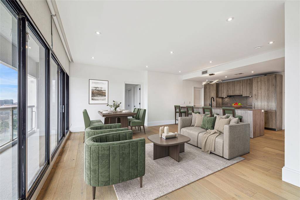 The open living / dining area provides the perfect vantage point to enjoy the balcony and view of Houston. Virtually Staged.