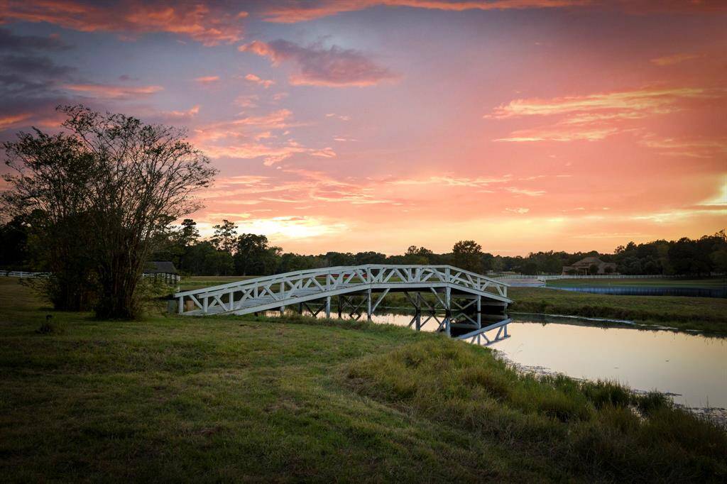 A private and charming bridge leads one to the island and stocked lake.