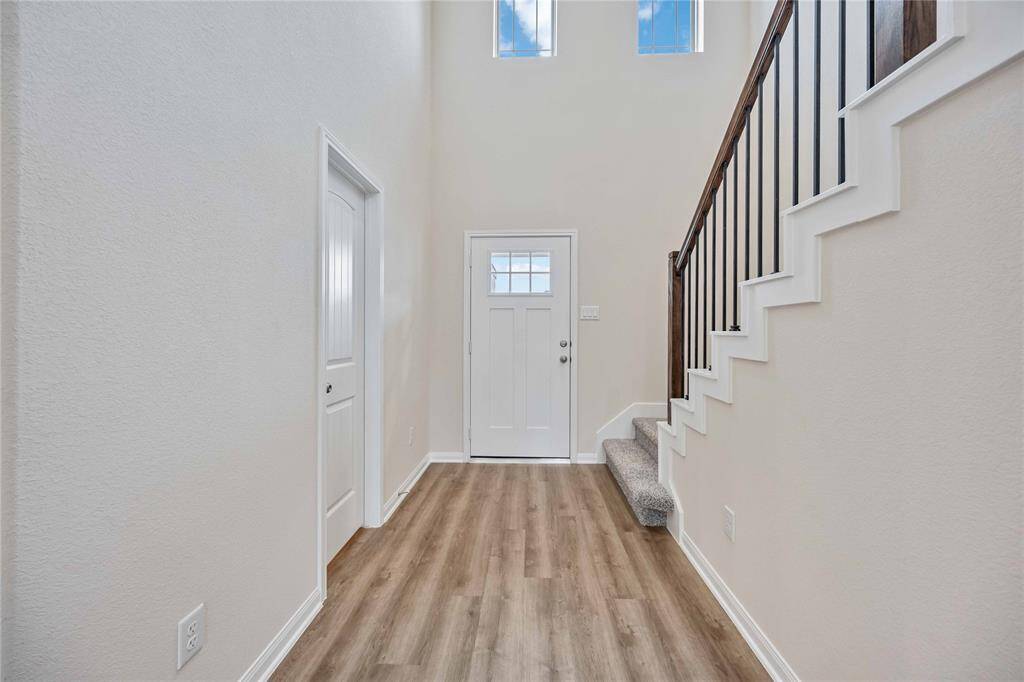 Gorgeous flooring & tall ceilings impress family & guests upon entry.
