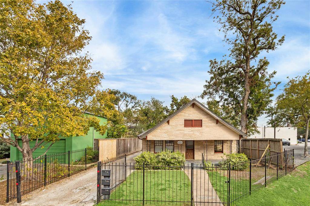 Property is full fenced with a private driveway and additional parking behind the main house