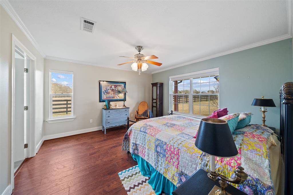 The bedroom in the guest house offers lots of natural lighting and wood flooring!