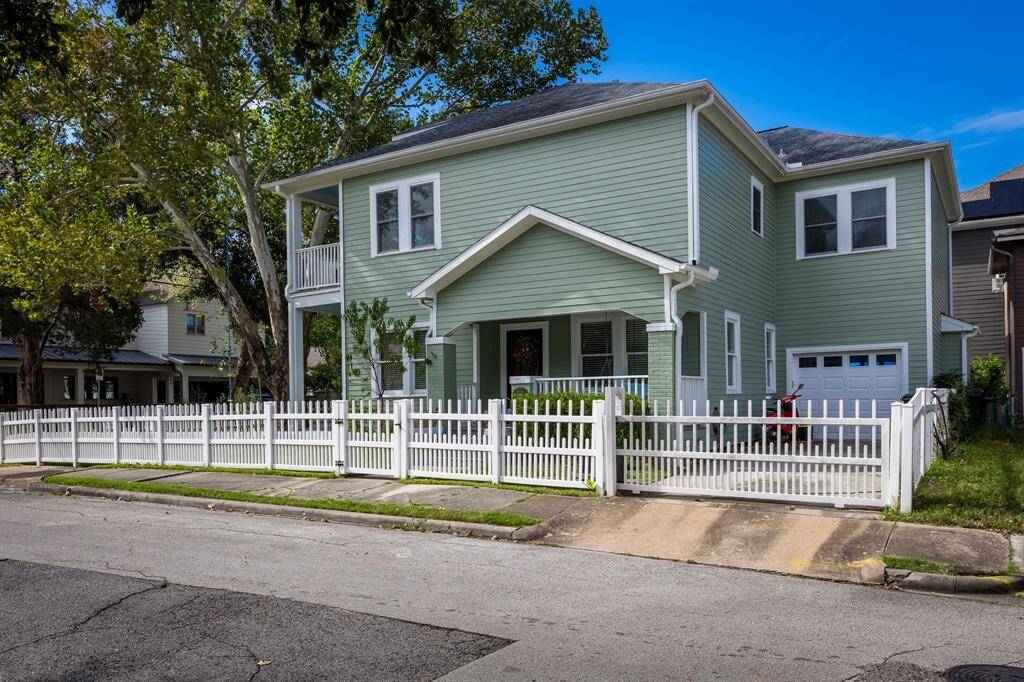 Charming side porch with swing and garage off Rural Street. Low maintenance composite picket fence really adds charm.