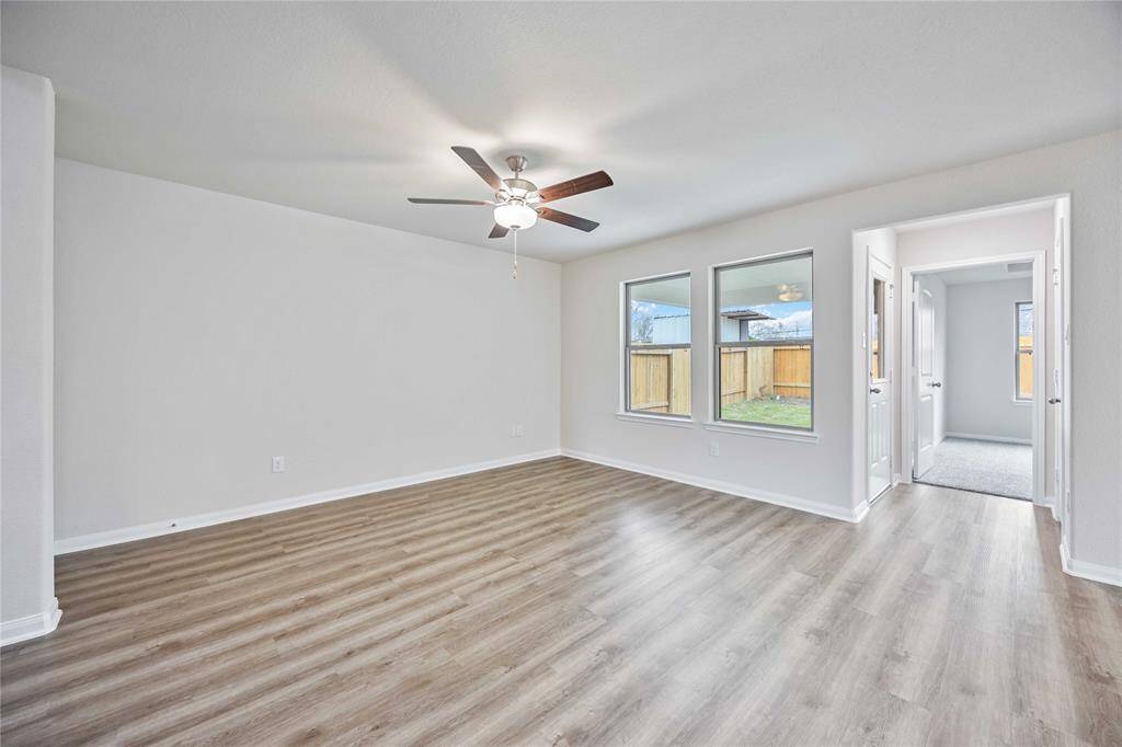 HUGE family room with ceiling fan! We just LOVE the flooring & tall ceilings!