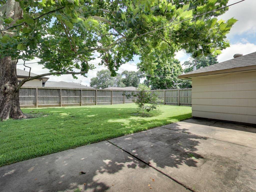 Large fenced yard and mature trees.