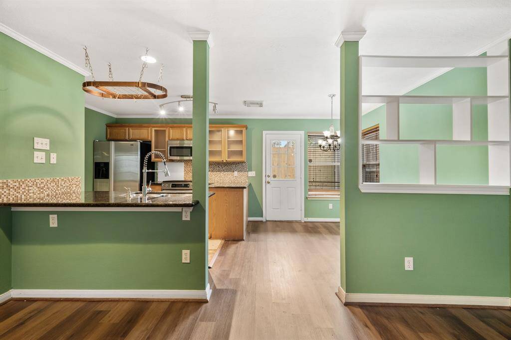 WOW! This living room is the perfect place to entertain family and friends as it offers a seamless, open floor plan. Easy access to your amazing kitchen and dining space!