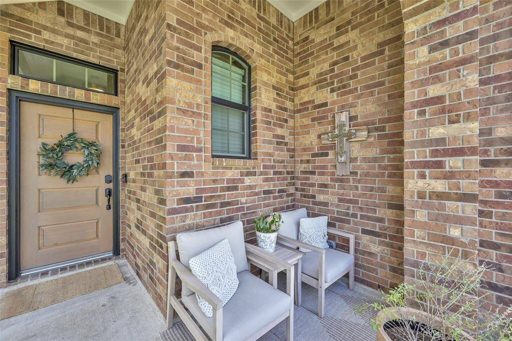 This is a cozy, welcoming frontporch with a wood-grain staineddoor and small porch perfect forrelaxing outside