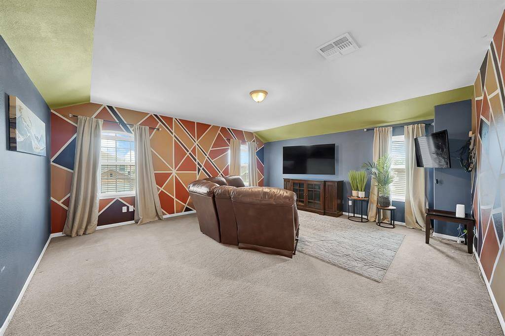 Upstairs gameroom has lots of lighting, designer paint and lots of space for entertaining