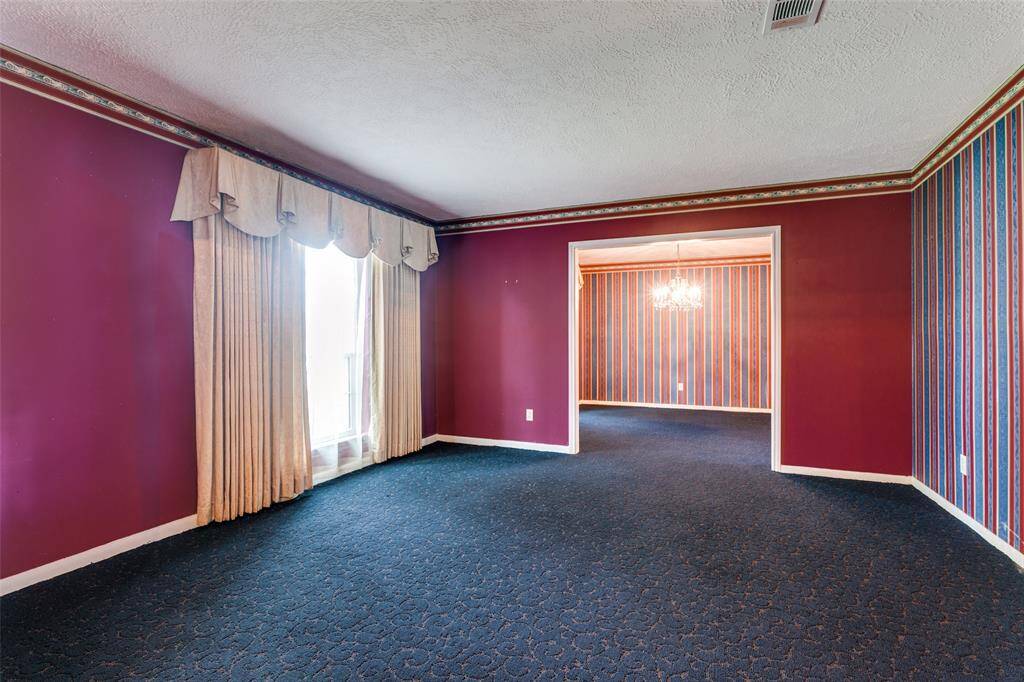 The formal living room is very spacious - could be a perfect place for a piano.