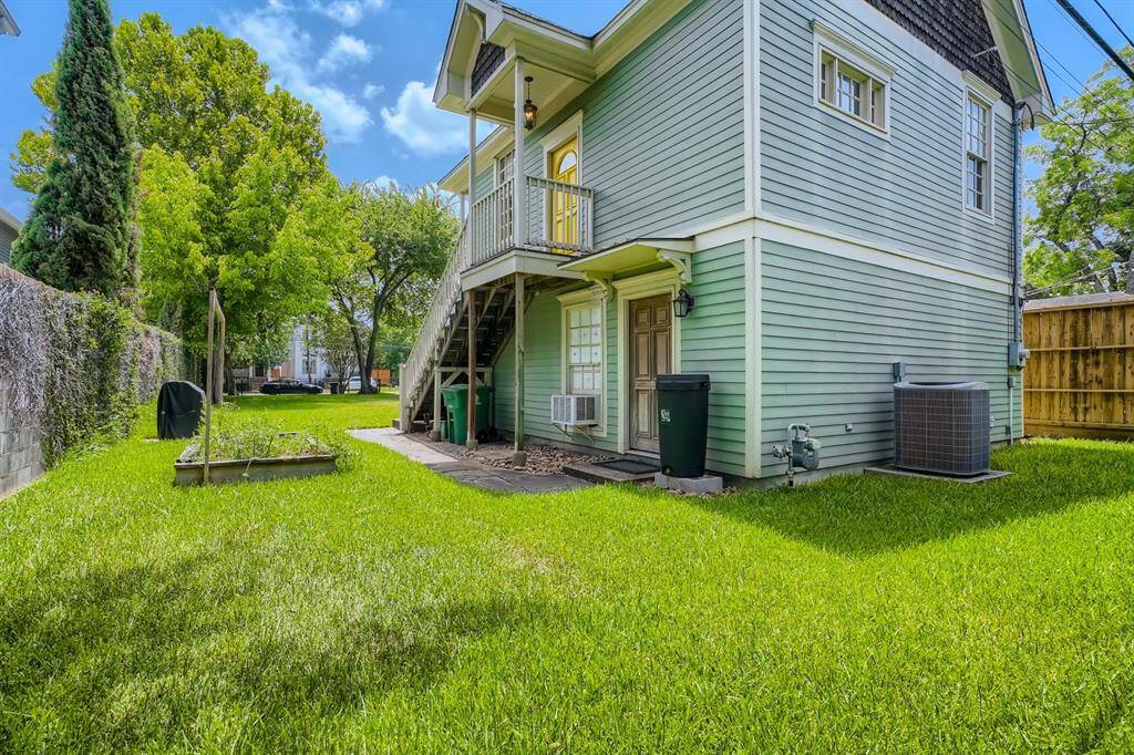 Lush grass and mature trees run throughout the property.
