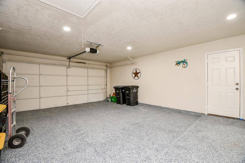 The garage has epoxy floor, and recessed lighting. It is very spacious!