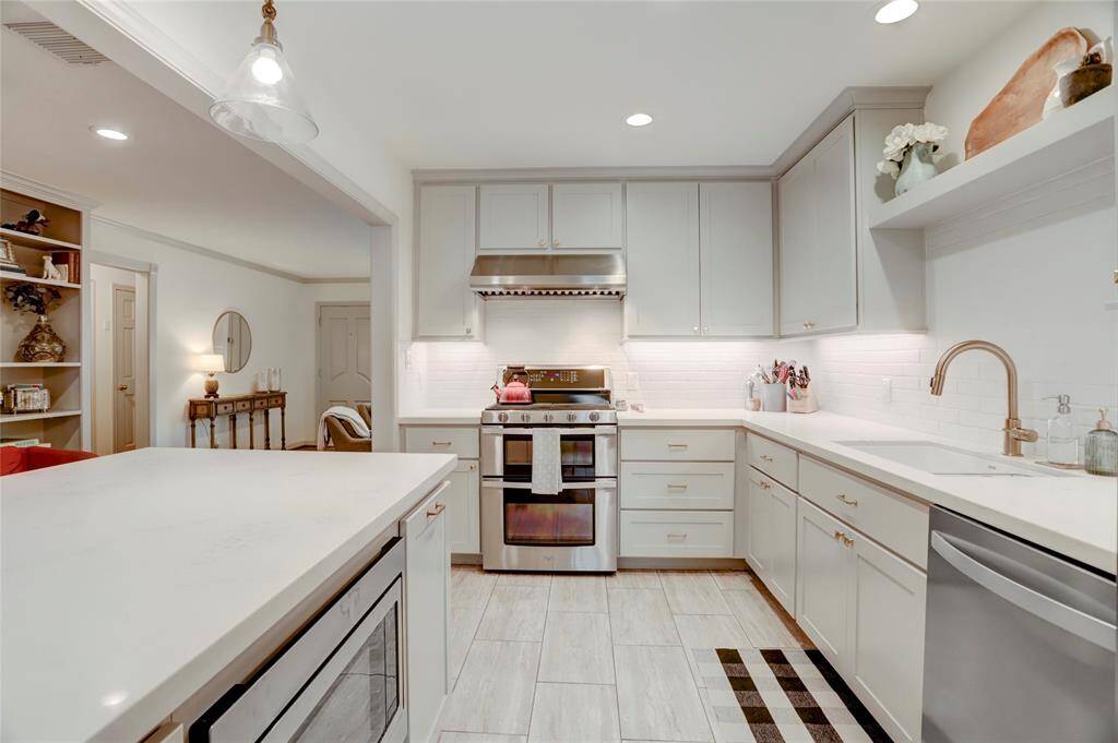 The updated kitchen has ample counter and cabinet space and looks out to the sitting room.