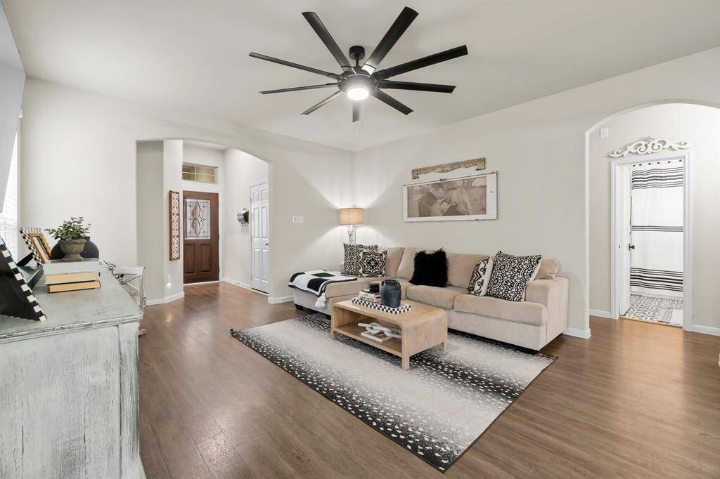 Another view of the inviting living room opening to a hallway which includes two spacious bedrooms & a second full bath.