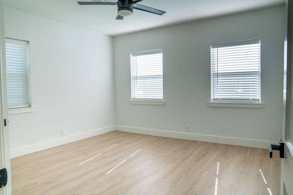 Bright bedroom with  large windows, offering ample natural light and plenty of space.
