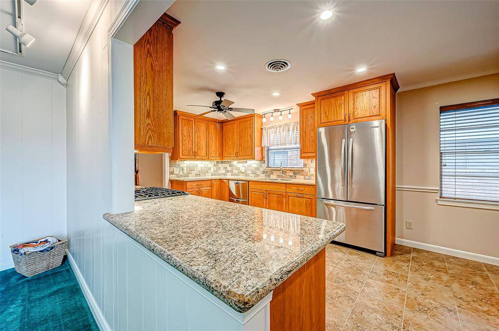 The expansive granite countertops provide plenty of room for meal prep, baking, or simply gathering with loved ones over a cup of coffee.
