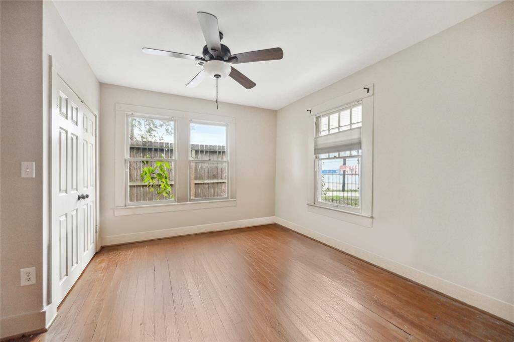 Primary bedroom in front corner of the home. Double door closet and ceiling fan.